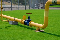 Image of main gas pipe valve overlap on background of green grass