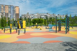 Survey view of colorful large playground in city park. Empty modern outdoor playground in the middle of spring. Beautiful urban place for kids games and sport