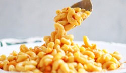 Vegan Mac and Cheese made with a cashew cream sauce - close up, white background