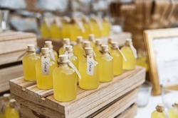Bottles of limoncello on wooden stands. Closed with corks. Inscriptions in Italian 