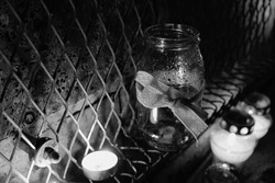 Candles lit outside the cemetery church on the day of the dead.All Saints Day.A burning candle intended to express memory of the deceased who have already achieved salvation.The wick burns in the cand