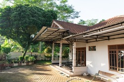 One of the houses in Indonesia with trees and ornamental plant pots.
