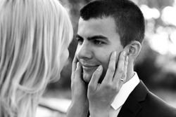 B&W beautiful elegant  blonde bride touching handsome brunette groom close-up
