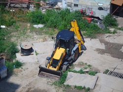 Yellow excavator (digger, bagger) on the construction site
