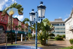 Blue sky, palms and street lamp in Fort de France, Martinique Island. Fort de France is the capital of Martinique island, French West Indies.