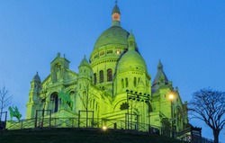 The Basilica Sacre Coeur lit with green light for celebrate St. Patrick's Day, Paris, France