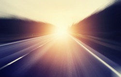 abstract blurred image, sunrise on an empty road
