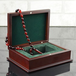 Red praying beads tasbeeh in luxury wooden box. Muslim traditional gift. String of beads for pray, Quran reading, islamic traditions culture. Ottoman, Turkish, Arabic, Lebanese moslem belief.