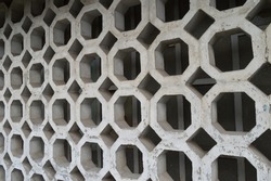 an old concrete decorative wall made of octagonal and square elements