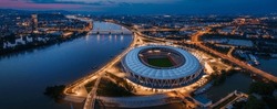 Budapest, Hungary - Aerial panoramic view of Budapest at dusk, including illuminated National Athletics Centre, Rakoczi bridge, Puskas Arena and MOL Campus skyscraper building at background at sunset