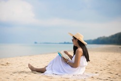 Lonely Woman relaxing on the beach on Khao Lak beach, white sand, clear water at andaman sea Phang nga Thailand