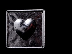 aluminium metal heart love concept on a black background