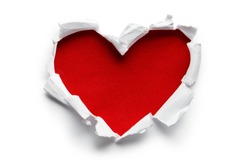 Heart shaped red hole torn through paper, isolated on white background