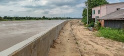 Newly built strong cement walls, to prevent water from dams flooding houses, in rural areas of Thailand.