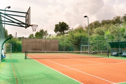 Mini outdoor sports ground, facilities for training and playing football, basketball, volleyball and tennis court. Active recreation in the park on a summer day surrounded by trees
