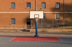 Basketball hoop against building with windows