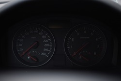 Dashboard on a dark background. Engraved numbers of the speed of the car. 