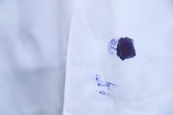 Dirty blue ink stain on bag shirt  from using pen in daily life activity. dirty stains for cleaning concept.