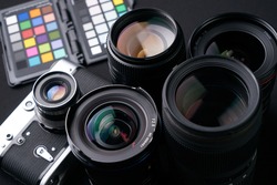 Close up photo of Collection of camera lens well organized over black background.