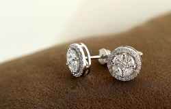 
Diamond jewelry. Diamond earrings on brown velvet