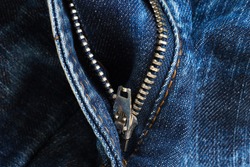 texture of worn blue jeans with zipper