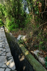 Path and ditch between Titus Tunnel and Beşikli Cave by trekking route in Çevlik, Samandag, Hatay.
