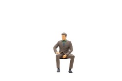 Miniature people Businessman sitting isolated on white background with clipping path