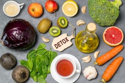 Food for detoxification. Detox food purify body of toxins, have beneficial health effects. Concept of purification. Small cutting board with word detox. Top view