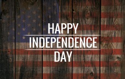 Inscription Happy independence day on usa flag. Grunge background. Wooden texture.