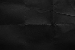 Black paper background. Old texture. Crumpled texture. Fold