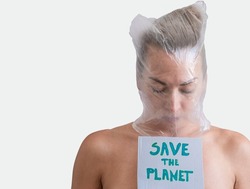 a young girl with her head wrapped in the plastic bag, holding a sign save the planet, environmental concept