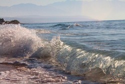 Splashing waves of a blue sea on a summer day. Selective focus. High quality photo