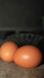 Egg, Brown raw chicken eggs, on a bowl background, on a cement wall, contain protein and cholesterol, farm produce.