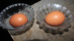 Egg, Brown raw chicken eggs, on a bowl background, on a cement wall, contain protein and cholesterol, farm produce.