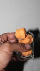 Corn balls pile. Cheese puffs with spices, crunchy snacks, scattered salty corn balls top view, Yellow, made from corn, salty, in a glass bowl, Asian, Indonesian food, puffed ball cheese corn chips.
