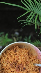 Mie goreng or Simple fried noodles in pink ceramic bowl, spicy, with sauce, soy sauce, instant food, instant noodle, jung food, asia food, spicy.
