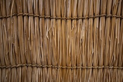 a straw tied with ropes made from straw and arranged into a wall