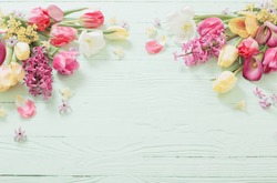 spring flowers on green wooden background