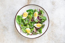 egg vegetables salad green leaves mix spinach, arugula, lettuce on the table wholesome food healthy meal snack copy space food background rustic. top view keto or paleo diet veggie or vegetarian