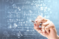 Male hand writing mathematical formulas on blurry background. Science and algebra concept. Double exposure 