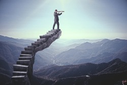 Businessman looking into the distance on abstract stairs. Landscape background. Research and vision concept 