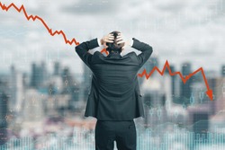 Back view of stressed young businessman looking at downward red arrow on blurry city background. Decrease, stats and investment concept. Double exposure 