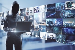 Online piracy concept with noface hacker with laptop on media wall with video archive background