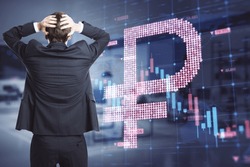 Back view of worried young businessman with abstract glowing falling forex chart with dollar sign on blurry interior background. Trade, finance, crisis and economy concept. Double exposure