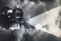 Vintage camera making a film in the dark room with clouds