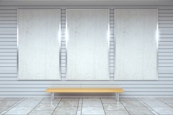 Blank white posters on the wall in empty subway with wooden bench on the floor, mock up 3D Render