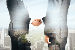 Businessmen shaking hands on city background. Double exposure
