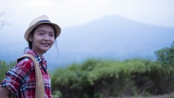 Happpy yoing girl at beautiful view point at Phu Pa Po Loei Thailand.