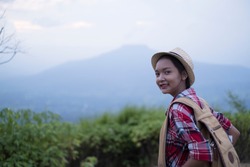 Happpy yoing girl at beautiful view point at Phu Pa Po Loei Thailand.