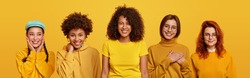 Group of happy young women on yellow background. Collage of five mixed race models, wear same yellow clothes, makes gratitude gesture, being in high spirit, look gladfully at camera. Collection